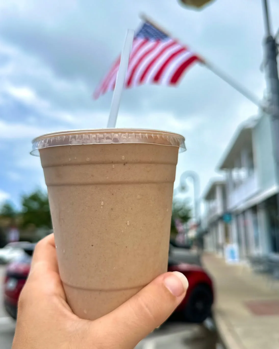A smoothie held up on Reid Avenue with a flag behind it